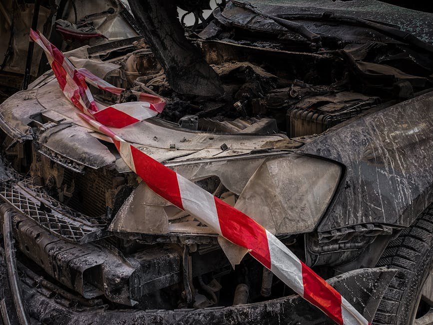 Close-up of a wrecked car covered with safety tape in Kyiv, Ukraine.