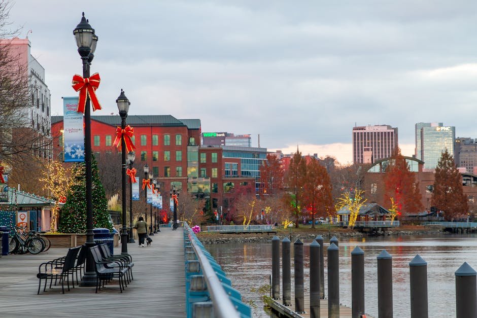 Festively decorated Wilmington riverfront with holiday lights and bows along the walkway.